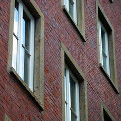 Obraz premium apartment windows on side of brick building