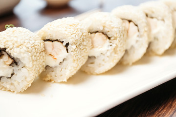 Jpanese sushi food. Maki ands rolls with tuna, salmon, shrimp, crab and avocado. Top view of sushi.