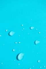Water drops with copy space on blue background, top view. Vertical