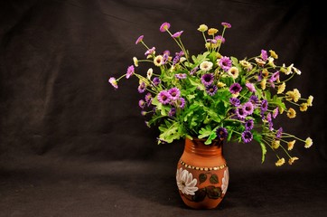 bouquet of flowers in a vase on wooden table