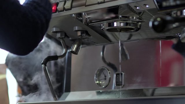 Espresso coffee from machine. Close up footage.