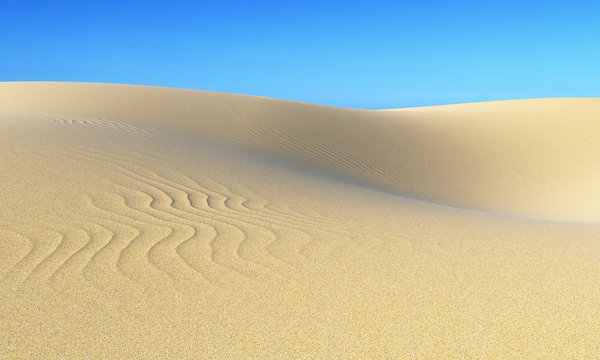Smooth sand dunes under blue sky