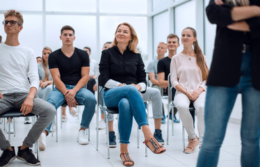 group of diverse young people sitting in a conference room