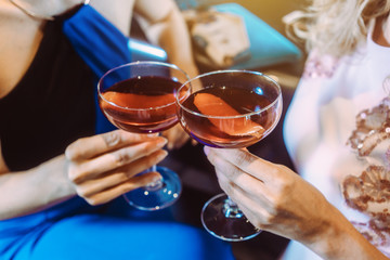 Close up on women holding cocktails in a bar