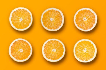 Six Raw Bio Orange Fruit Slices on Orange Background