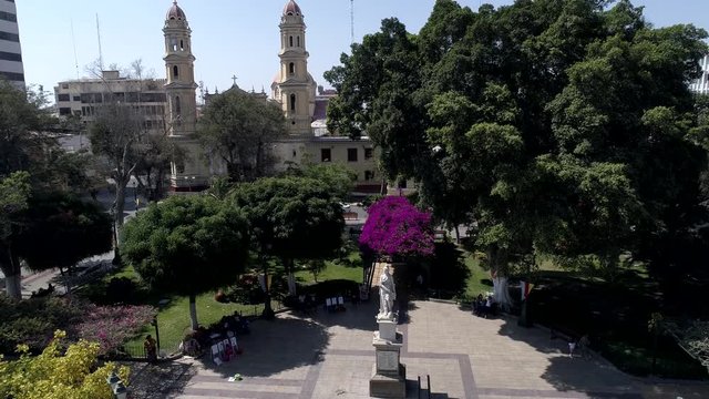 Crane-up aerial drone view move of the main square of Piura city at a sunny afternoon in Piura Region, Peru