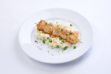 chicken kebab with rice and vegetables on the white background