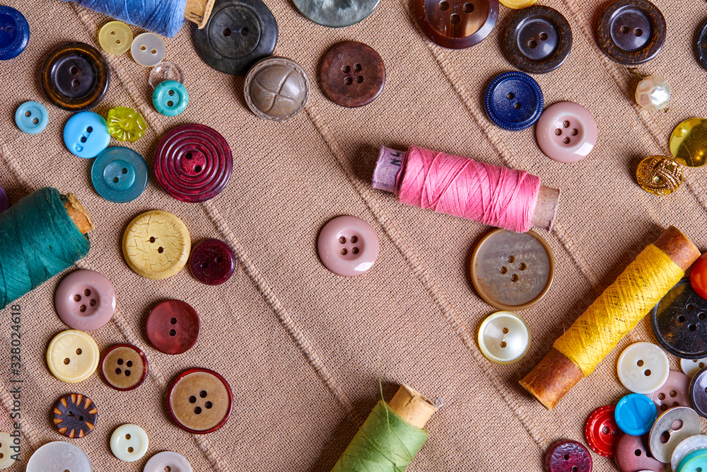 Poster background and texture of multicolored antique buttons and sewing tools