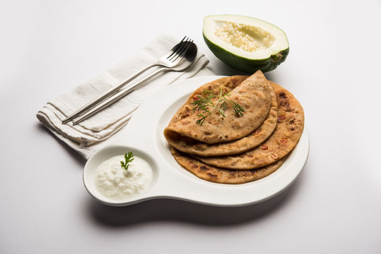 Raw Papaya Paratha or Papita ke Parathe made using Made using papaya, wheat flour, cumin seeds, ginger. Popular Indian food recipe served hot with curd. selective focus