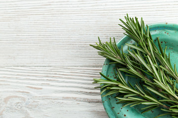 Fresh rosemary on plate. Space for copy