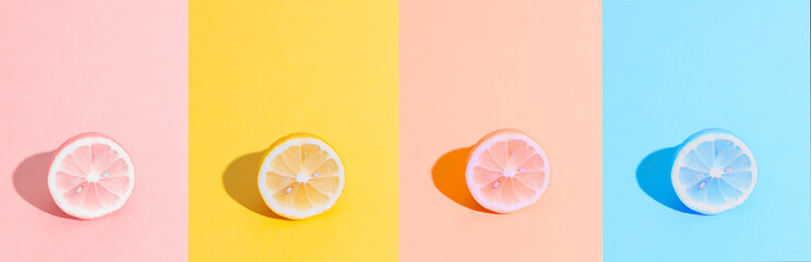 Banner format. Sliced lemon in different colors. Summer, freshness concept. Yellow, pink and blue...