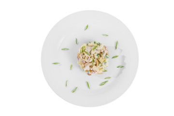 salad with mushrooms, honey mushrooms, cucumber, potato, bell pepper, sour cream, mayonnaise, garnished with green onions on plate, view from above, white isolated background