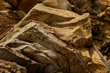 Fototapeta na wymiar close up sandstone texture background, natural surface divided by huge cracks. Background on theme geology
