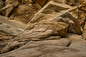 close up sandstone texture background, natural surface divided by huge cracks. Background and copy space for text