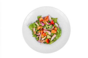Vegetable salad with lettuce, red onion, cucumber, tomato, bell pepper, oil on plate, white isolated background, view from above. For the menu, restaurant bar cafe