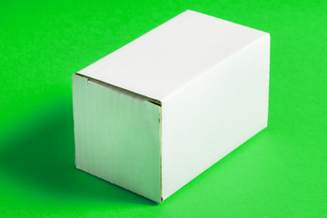 White carton packing box on green background