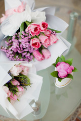 Three bouquets of pink flowers and some greenery