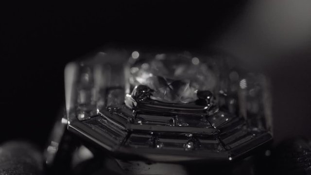Man crafting a diamond ring jewel with his tools 