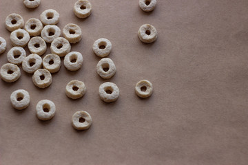 Abstract pattern of small round snacks on craft paper.