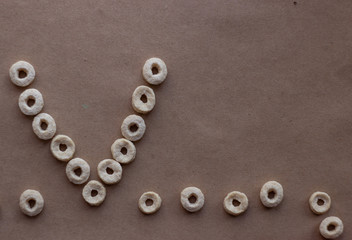Abstract pattern of small round snacks on craft paper. characters and letters