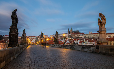 Morning at Charles Bridge - view at Hradcany Castle just before sunrise