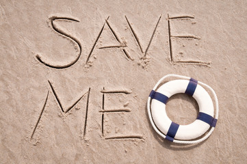 Save Me! message handwritten on the beach with lifesaver in smooth sand copy space