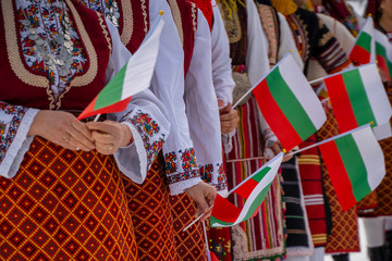 Bulgarian Flag. Woman holding Flag of Bulgaria in traditional clothing. Day of Liberation parade....