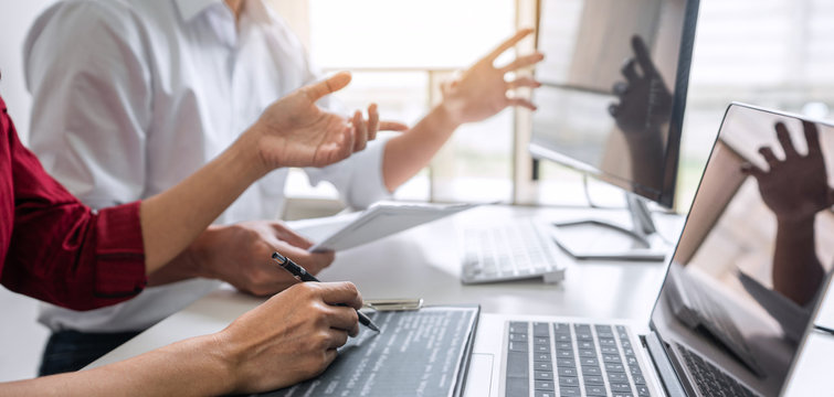 Programmers cooperating at Developing programming and website working in a software develop company office, writing codes and typing data code, Programming with HTML, PHP and javascript