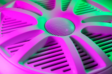 Colorful lights of car stereo and car speakers background.  Car music audio speaker in green and...