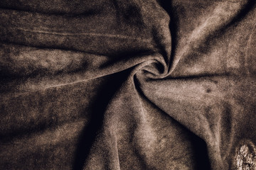 Dark brown suede leather texture background.