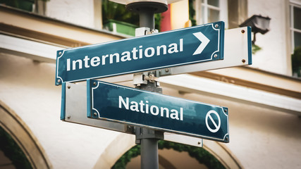 Obraz premium Street Sign to International versus National