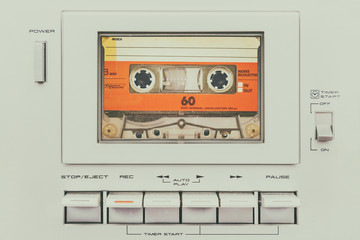 Retro styled image of a vintage audio cassette player - obrazy, fototapety, plakaty