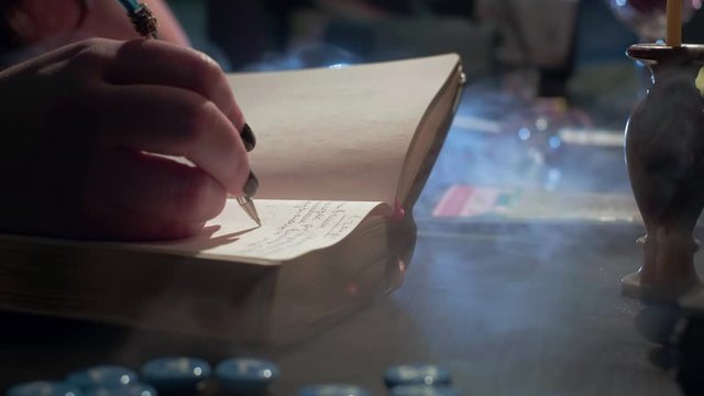 The witch is reading a magic book. Makes notes of a ritual ceremony. Conducts a spiritualistic session, communicates with the spirits and souls of the dead. Paranormal activity