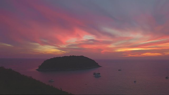 stuning sunset above Man island in front of Promthep cape and wind turbine viewpoint. Promthep cape and wind turbine .viewpoint are popular place in Phuket ..
