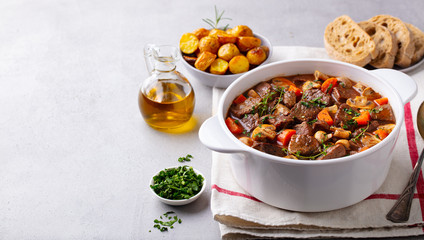 Beef bourguignon stew with vegetables. Grey background. Copy space. - obrazy, fototapety, plakaty