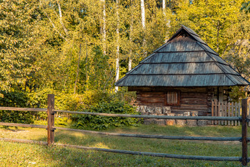 rustic rural wooden cabin village house Ukraine country side scenic nature environment sun light on foliage