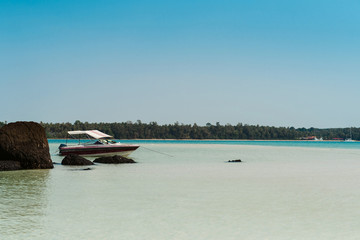 Fototapeta na wymiar Beautiful sea landscape with tropical coast and the speed boat