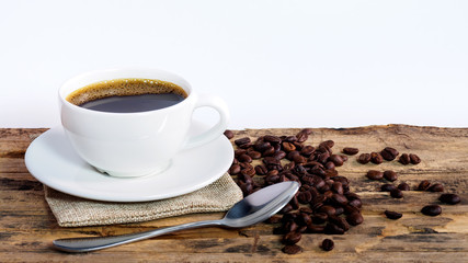 Coffee cups and coffee beans roasted on a wooden table