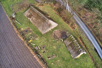 Historical houses with traditional reed grass roofs, vertical aerial view