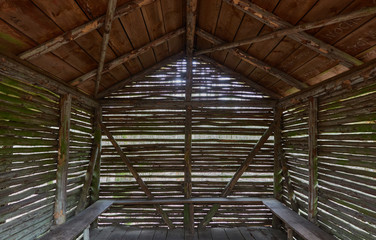 Hut made of thin wooden sticks to protect hikers, view through the interior