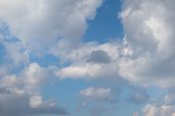 Beautiful white clouds of various shapes against the blue sky in early spring