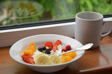 Healthy breakfast or snack curd with fruit and nuts. The concept of nutrition for weight loss. Keto breakfast. Keto lunch idea. cottage cheese or yogurt with berries on a window cup of coffee or tea