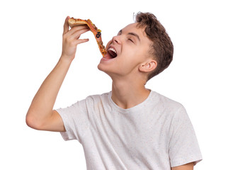 Happy beautiful young teen boy appetizing bites slice of pizza. Close up portrait of child with delicious Italian pizza, isolated on white background. Guy eating fast food.