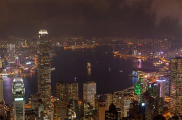 Cityscape buildings illumination reflected in Hong Kong bay