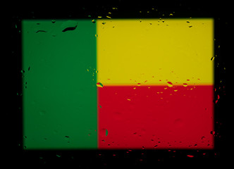 National Flag of Benin. Abstract photo with water drops on a glass.