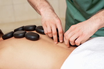 Back massage with massage stones.