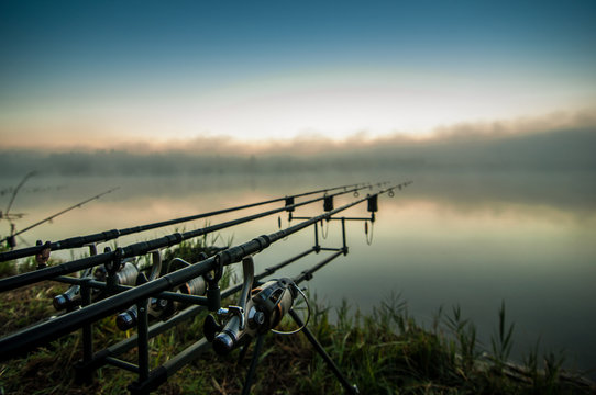 Fishing adventures, carp fishing. Fisherman on a lake shore with