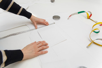 Image of designer hands working in workshop. Woman in process of creating new clothes collection.