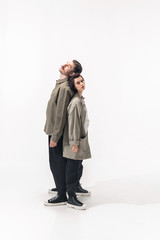 Confidence. Trendy fashionable couple isolated on white studio background. Caucasian woman and man posing in basic minimal stylish clothes. Concept of relations, fashion, beauty, love. Copyspace.
