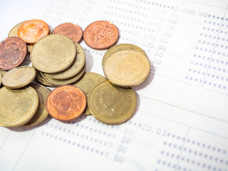 Thai Baht Coins colors Gold set in the mountains on Bank account book,Is the currency of Thailand.For business expenses,Coin is in a jar of money saving,White background